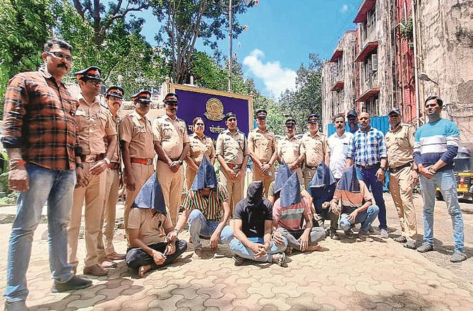 The accused who committed the robbery can be seen in police custody.