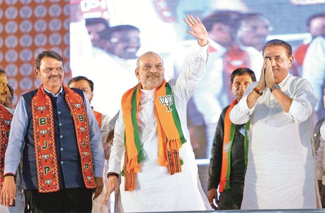 Amit Shah (centre), with Farnavis and Praful Patel. Photo: PTI