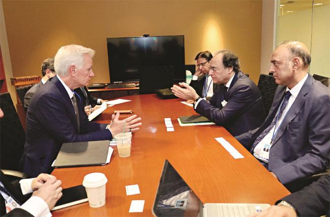 Pakistan`s Under-Treasurer Muhammad Aurangzeb Khan with IMF officials. Photo: INN
