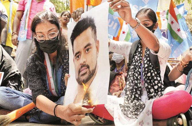 Workers of the Congress student organization `NSUI` protesting against Parjul Ravana on Tuesday. Photo: PTI