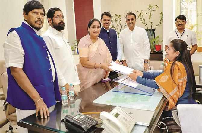 Sunitra Pawar filing the papers with important leaders. Photo: PTI