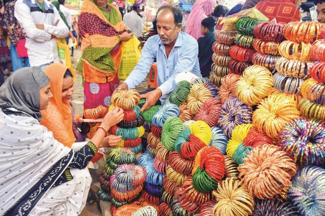 A scene of buying and selling bangles in a market in Mur Shadabad. Photo: PTI