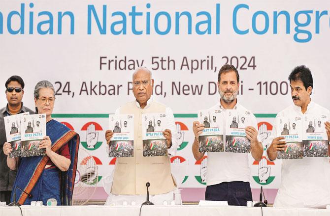 KC Venugopal, Rahul Gandhi, Mallikarjan Kharge and Sonia Gandhi releasing the party`s election manifesto. Photo: PTI