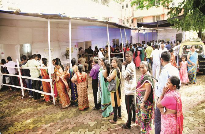 A queue of voters can be seen outside a polling booth.File photo