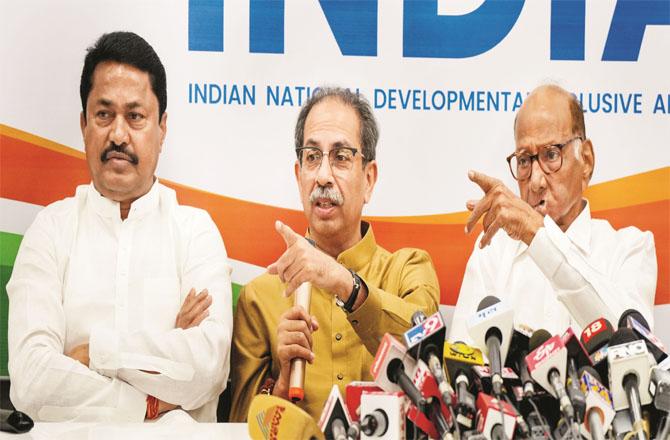 Uddhav Thackeray addressing the media. Sharad Pawar and Nana Patole can also be seen together. Photo: PTI