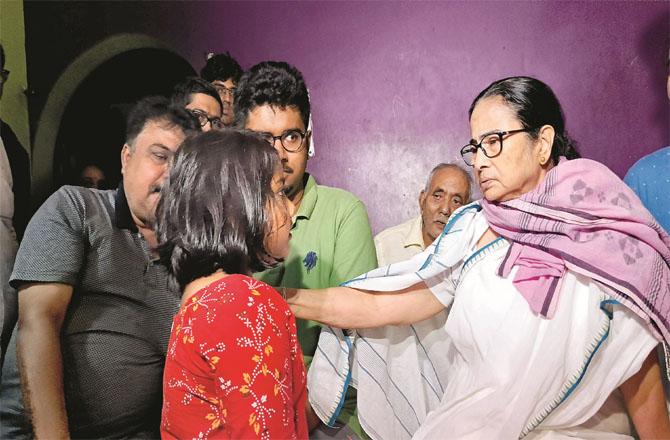 Mamata Banerjee was comforting the people of a house affected by the storm.Photo: PTI