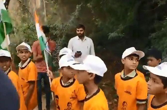 School students wearing t-shirts with Savarkar`s picture in the tricolor rally. Image: X