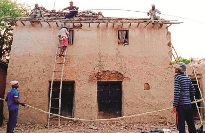 Artisans trying to build a structure for plastering over mud walls. Photo: INN