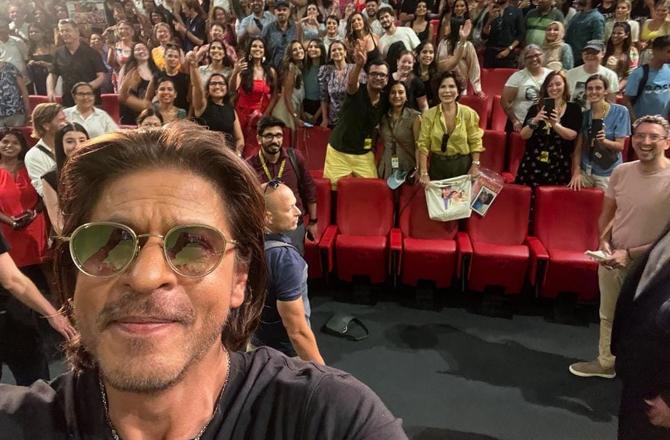 Shah Rukh Khan taking a selfie after addressing the media during the Lacarno Film Festival. Image: X