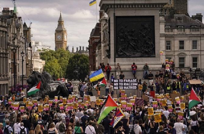 People hold placards against white racism at a London rally. Photo: PTI