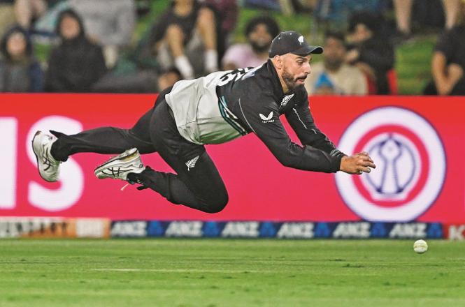 Daryl Mitchell of New Zealand trying to stop a ball on the boundary. Photo: PTI