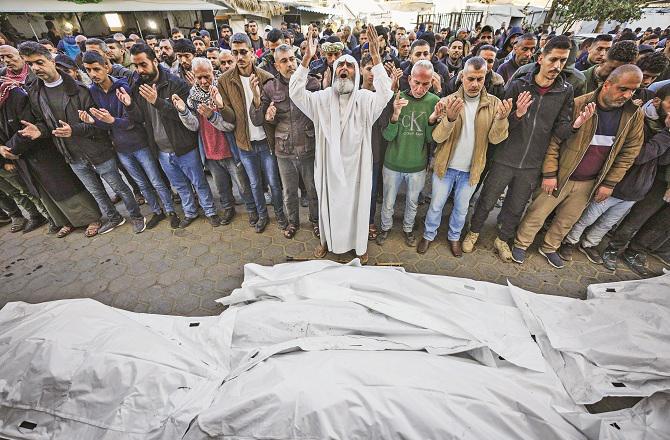 Prayers are being offered outside Al-Aqsa Hospital for those martyred in the Israeli attack. Photo: PTI.