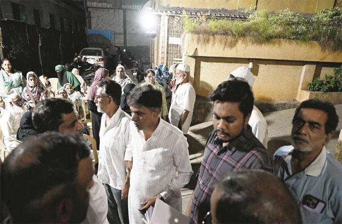 Relatives and friends outside the residence of Anam Muzaffar Sheikh, who died in the Kurla bus accident.