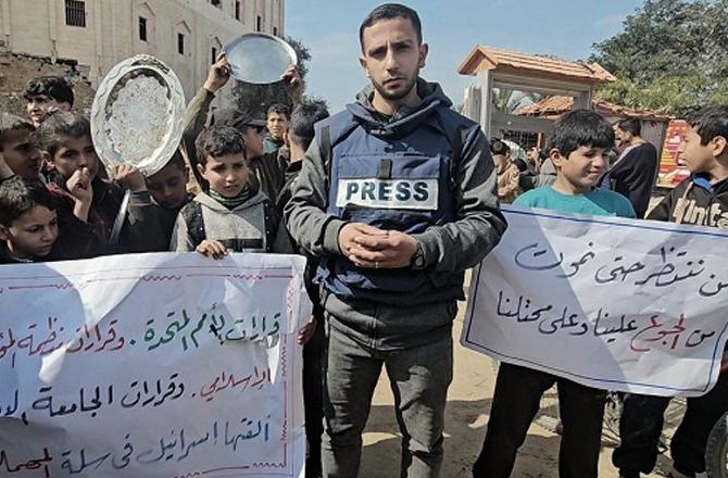 Palestinian children with a journalist during the rally. Photo: PTI