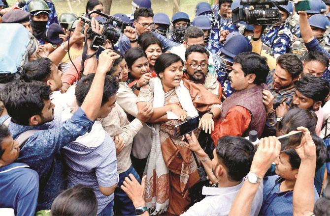 CPM youth leader Meenakshi Mukherjee being stopped by security personnel