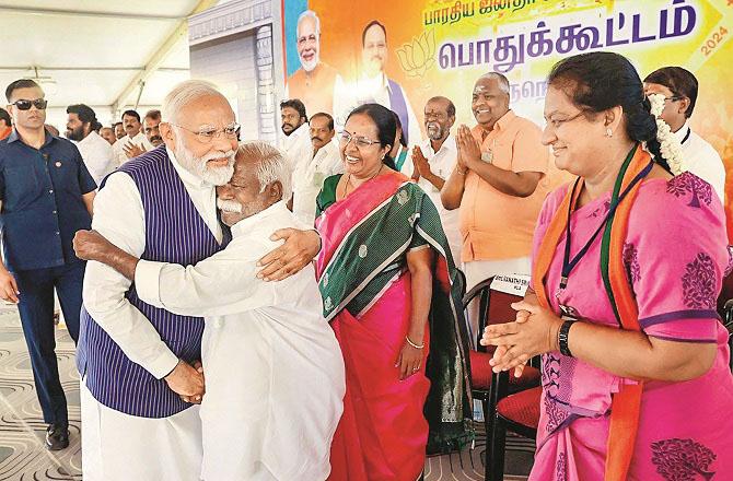 Modi hugs a man in Tirunelveli. Photo: PTI