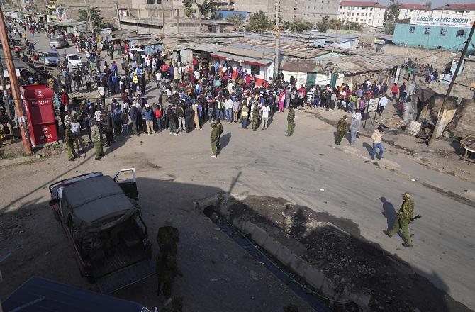 People can be seen in the area where the blast took place in Nairobi, Kenya. Photo: PTI