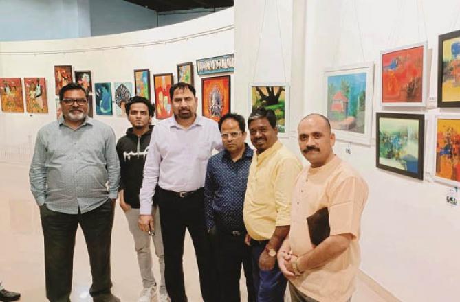 Drawing teachers of schools in an exhibition held at Nehru Centre. His paintings can also be seen behind. Photo: Inquilab