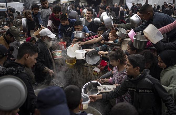 In Rafah, Palestinian children can be seen standing in line for food. Photo: PTI