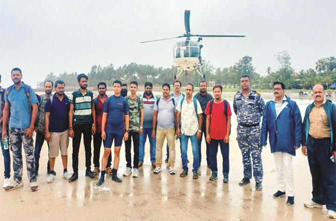 A coast guard and police team can be seen along with the ship`s crew on the beach at Alibagh. Photo: INN