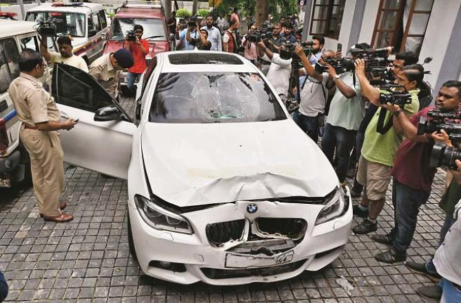 Police inspecting the BMW car while media representatives are also present. Photo: INN