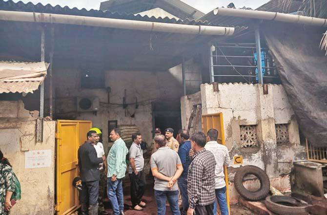 Police and fire brigade personnel are seen standing at the gate of the company. Image: Revolution