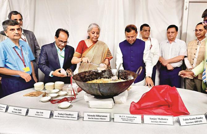 Finance Minister Nirmala Sitharaman distributing halwa before the lock-in process. Photo: PTI