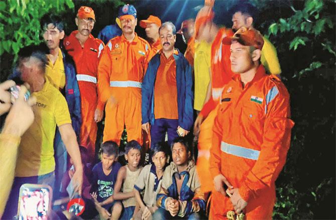 Members of the disaster management team with the rescued children. Photo: Inquilab