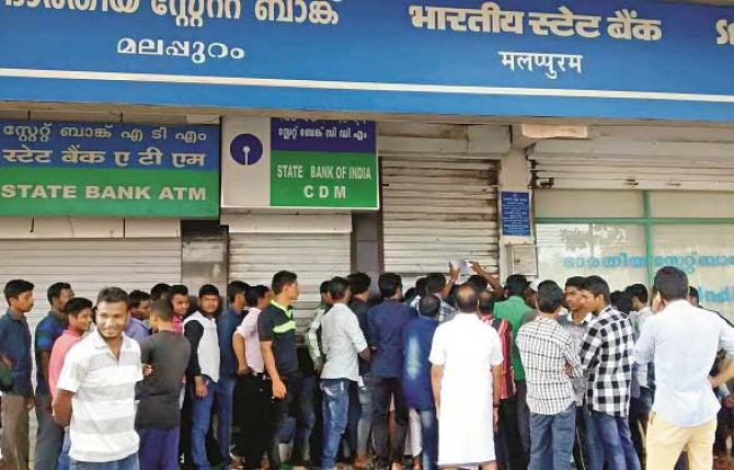 A photograph of people standing outside an ATM during demonetisation. Photo: INN