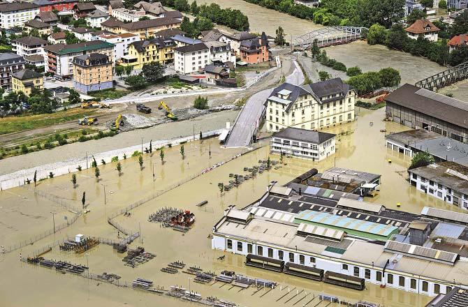 A highway and a railway line in a city in Switzerland were completely submerged in floods. Photo: AP/PTI