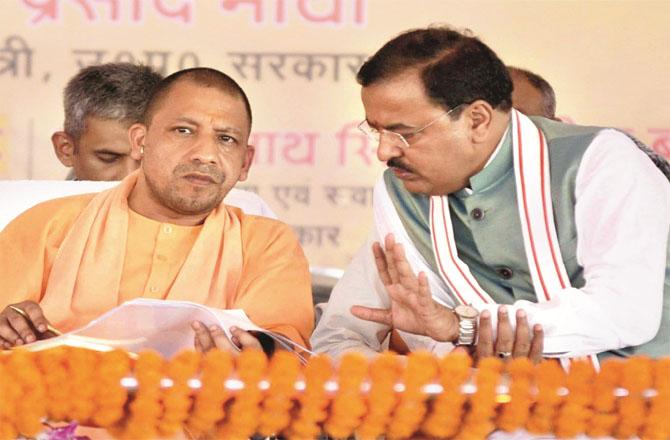 Uttar Pradesh Deputy Chief Minister Keshav Prasad Maurya and Chief Minister Yogi Adityanath. Photo: INN