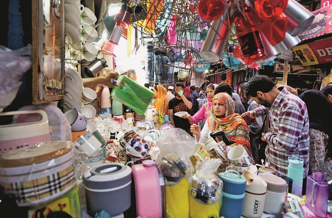 A crowd can be seen at a shop in Kashmir. Photo: PTI.