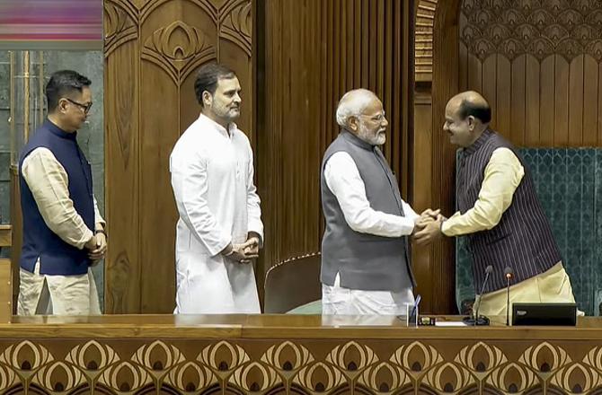 Om Birla shaking hands with Prime Minister Modi. Photo: PTI