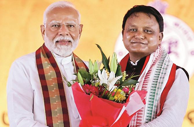 Prime Minister Modi with Chief Minister Mohan Charan Majhi. Photo: PTI.