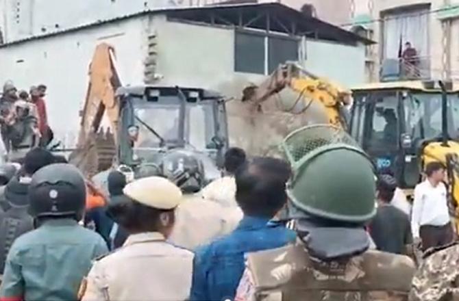 Police and local people can be seen during the demolition of the mosque. Image: X