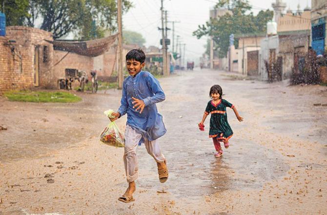 Children enjoy the rainy season and stay drenched in the rain for hours. Photo: INN.