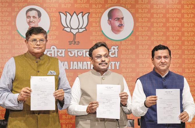 BJP leaders Anil Baloni, Vinod Thawde and Bejinath Patil releasing the list of party candidates.