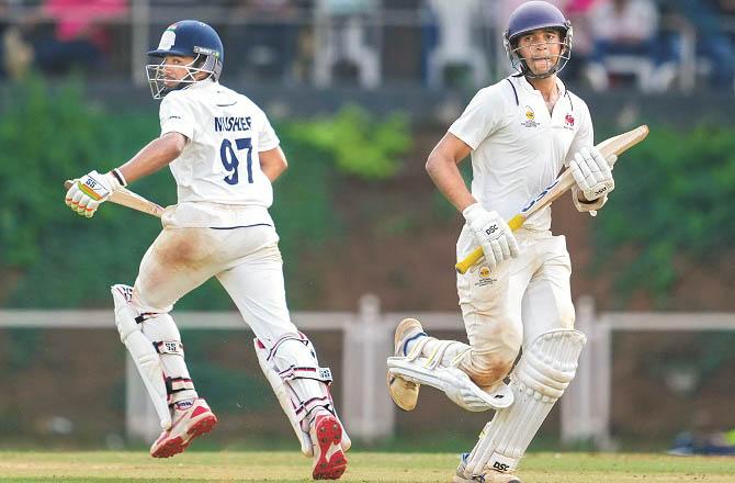 Musheer Khan runs for a run with his teammate. Photo: PTI