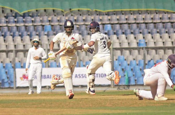Mumbai skipper Ajinkya Rahane and batsman Mushir Khan run for runs against Vidarbha. Photo: Inquilab, Atul Kamble
