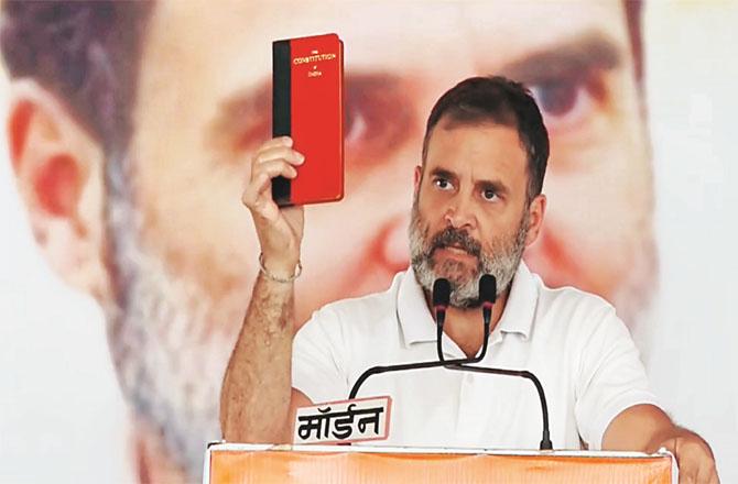 Rahul Gandhi can be seen holding a copy of the Constitution while addressing an election rally in Madhya Pradesh. Photo: PTI 