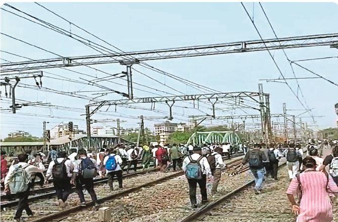Passengers can be seen walking on the tracks after getting off the trains due to the signal failure. Photo: INN