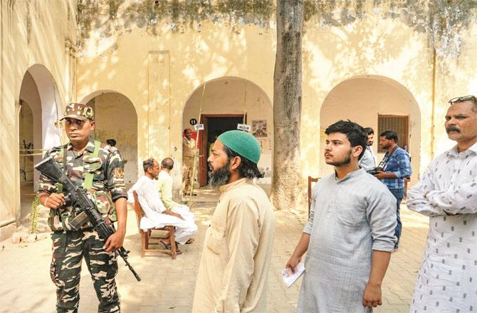 A scene of voters outside a polling booth in Bareilly. Polling was held in the third phase here. Photo: PTI