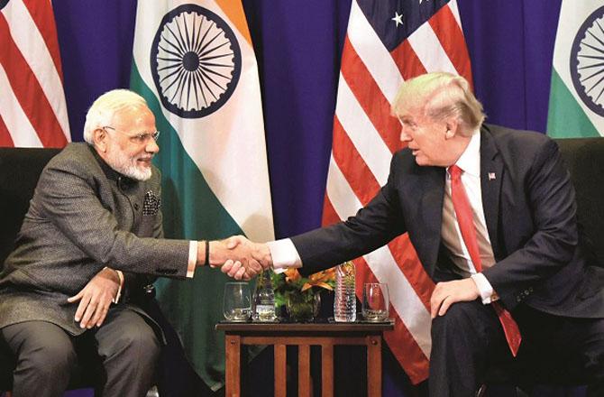 Prime Minister Modi shaking hands with President Trump. File photo