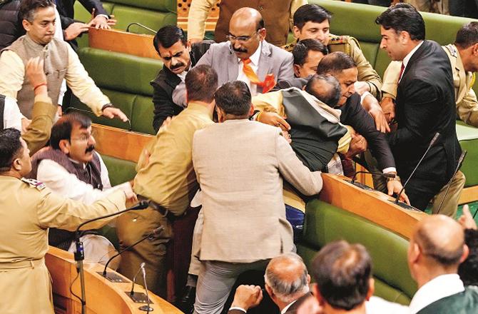 Seeing the poster demanding restoration of Article 370, the BJP members got angry and started beating. Photo: PTI.