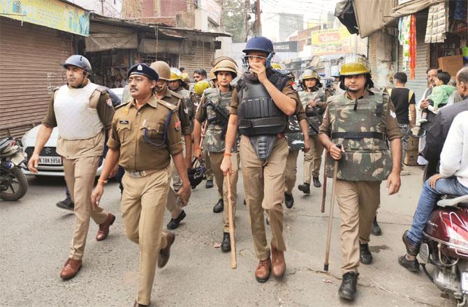 Police are marching in the affected areas to bring the situation under control in Sambhal. Photo: PTI