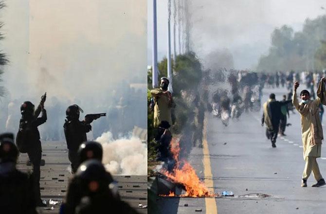 Police officers firing tear gas shells at PTI protesters. Photo: INN