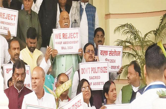 Members of opposition parties protest on the steps of the assembly against the amendment bill and other issues.