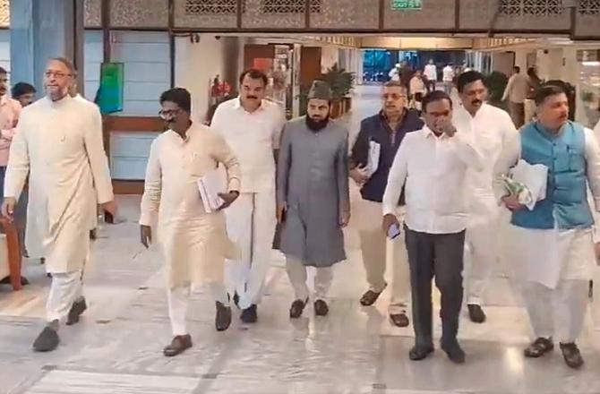 Opposition members, coming out of Parliament. Photo: PTI.