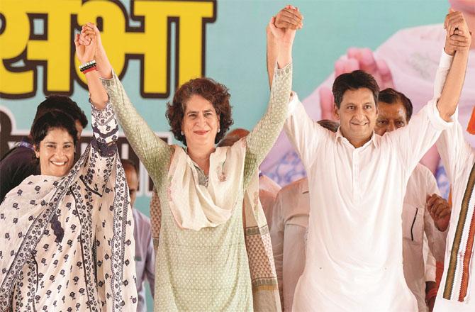 Priyanka Gandhi, Vinesh Phogat and Dipendra Hooda at an election rally in Julana .(PTI)