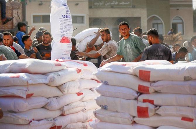 United Nations workers distributing aid in Gaza. UNRWA: X